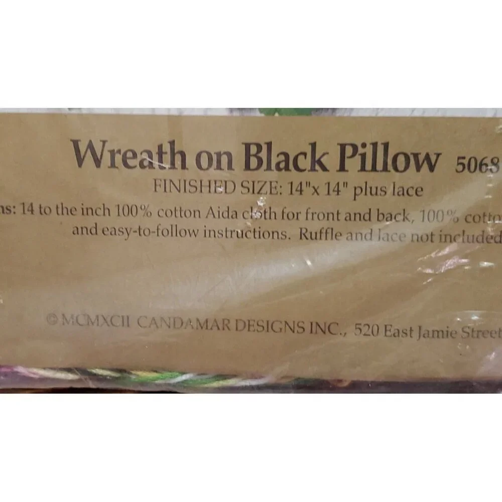 Something Special Counted Cross Stitch Kit #50687 wreath on black pillow.